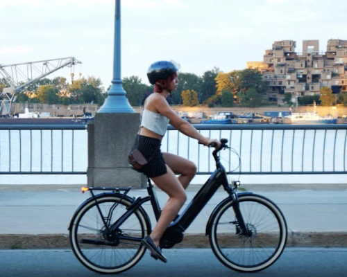 A girl is riding the Women Electric Bike of O2feel at sea side